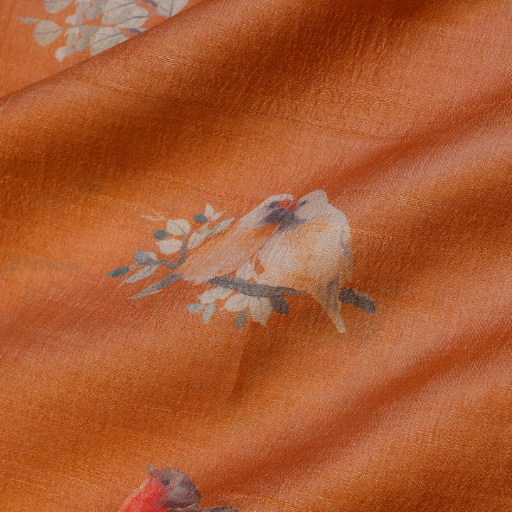 Light Orange Color Tussar Fabric With Floral And Bird Motif Pattern