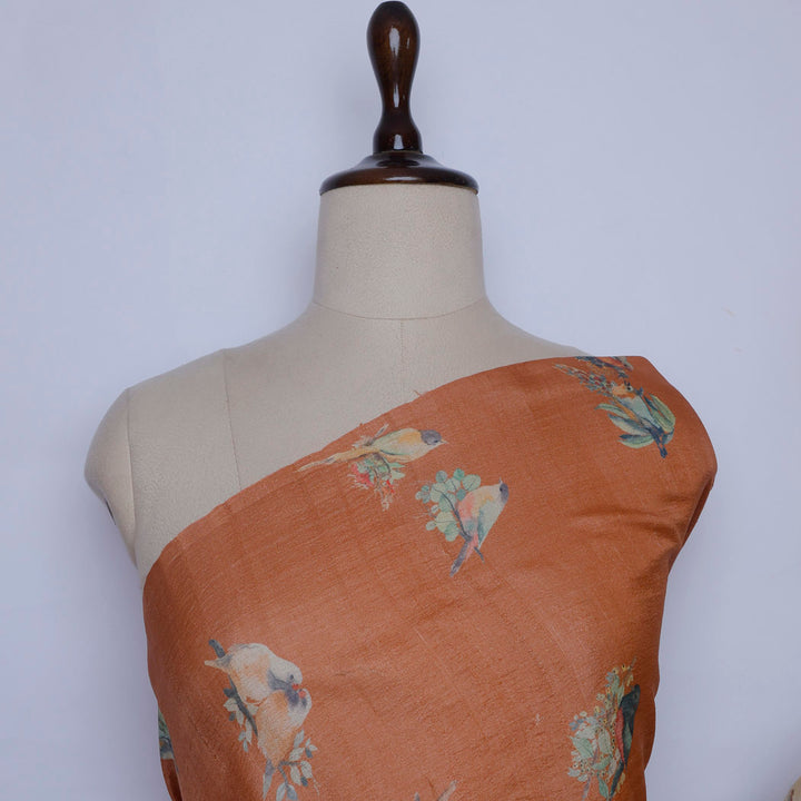 Light Orange Color Tussar Fabric With Floral And Bird Motif Pattern